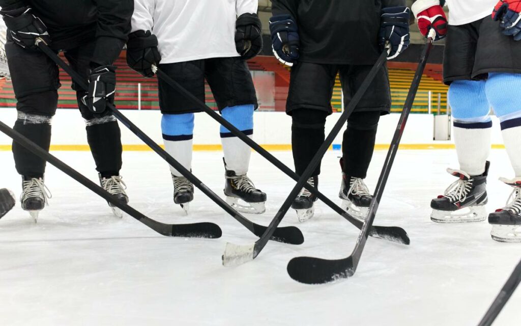 sticks, skates on ice